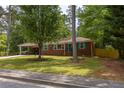 Charming brick ranch home featuring turquoise shutters and a well-maintained front yard at 3761 Lindley Cir, Powder Springs, GA 30127