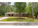 Charming brick ranch home with a lush front lawn and a covered carport at 3761 Lindley Cir, Powder Springs, GA 30127