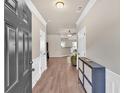 Inviting entryway featuring hardwood floors, neutral paint, and a modern storage cabinet at 635 Oakside Pl, Acworth, GA 30102