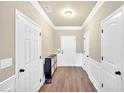 Bright entryway featuring hardwood floors, neutral paint, modern storage cabinet, and white trim at 635 Oakside Pl, Acworth, GA 30102