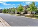 A row of inviting townhomes with well-manicured lawns and tree-lined street under a sunny sky at 635 Oakside Pl, Acworth, GA 30102