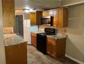 Kitchen features a black electric stove, microwave, and refrigerator at 6354 Shannon Pkwy # 13C, Union City, GA 30291