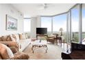 Cozy living room with floor-to-ceiling windows, hardwood floors, and comfortable seating at 2795 Peachtree Ne Rd # 2101, Atlanta, GA 30305