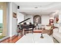 Elegant living room showcasing a grand piano, hardwood floors, and stylish decor at 2795 Peachtree Ne Rd # 2101, Atlanta, GA 30305