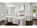 Modern kitchen with white cabinets, subway tile backsplash, large island with seating, and stainless steel appliances at 3481 Landen Pine Ne Ct, Atlanta, GA 30305