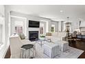 Bright living room featuring a fireplace, large windows, hardwood floors, and stylish, neutral-toned furniture at 3481 Landen Pine Ne Ct, Atlanta, GA 30305