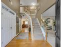 Grand foyer with hardwood floors, a staircase, and views into the kitchen at 6378 Grey Fox Way, Riverdale, GA 30296