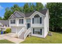 Charming two-story home featuring a two-car garage and a welcoming front entrance with a staircase at 115 Manx Dr, Grantville, GA 30220