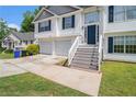 Charming two-story home featuring a two-car garage and a welcoming front entrance with a staircase at 115 Manx Dr, Grantville, GA 30220