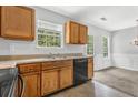 Kitchen featuring wood cabinets, a black dishwasher and double sink at 4115 Kensington Cv, Atlanta, GA 30349