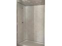 Modern bathroom shower featuring new gray and white hexagon tile, offering a sleek and contemporary design at 7301 Staton Se Pl, Acworth, GA 30102
