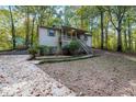 Charming home with natural surroundings and a quaint front porch at 12 Woodland St, Dallas, GA 30157