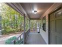 Inviting front porch featuring wood decking and views of the yard at 12 Woodland St, Dallas, GA 30157