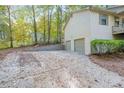 A home featuring a spacious two-car garage and a large parking pad at 12 Woodland St, Dallas, GA 30157