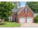 Charming brick home with a well-maintained front yard and a two-car garage at 2500 Madison Commons, Atlanta, GA 30360