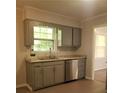 Well-lit kitchen features stone countertops, stainless steel dishwasher, and light gray cabinetry at 4274 Carrollwood Dr, Stone Mountain, GA 30083