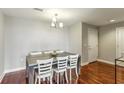 Minimalist dining space featuring a sleek table, modern chairs, and hardwood flooring at 195 14Th Ne St # 1706, Atlanta, GA 30309