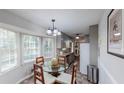 Cozy dining area featuring large windows, a glass table, and a view of the outdoors at 2668 Kings Way, Lawrenceville, GA 30044