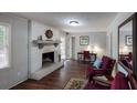 Comfortable living room with a whitewashed brick fireplace, hardwood floors, and stylish decor at 2668 Kings Way, Lawrenceville, GA 30044