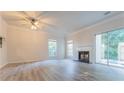Bright living room featuring modern flooring, a fireplace, and sliding glass doors to outdoor space at 3474 Washington Way, Atlanta, GA 30340
