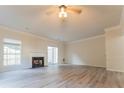 Spacious living room with fireplace, ceiling fan and sliding glass doors creating a relaxing atmosphere at 3474 Washington Way, Atlanta, GA 30340