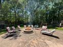 Enjoy this backyard's fire pit and social seating for relaxation and socializing, perfect for outdoor entertaining at 3594 Saddlebrook Dr, Loganville, GA 30052