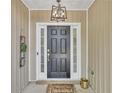 Front door area with wood paneled walls and a contemporary light fixture at 3610 Darcy Nw Ct, Kennesaw, GA 30144