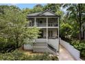 Charming two-story home with double balconies, inviting front porch, and beautifully maintained landscaping at 805 Ponce De Leon Ne Ter, Atlanta, GA 30306