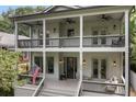 Inviting porch showcasing outdoor seating, classic lighting, and views from the home's double balconies at 805 Ponce De Leon Ne Ter, Atlanta, GA 30306