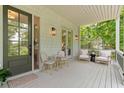 Charming front porch with comfortable seating, stylish lighting, and views of the home's exterior at 805 Ponce De Leon Ne Ter, Atlanta, GA 30306