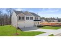 Well-maintained two-story home featuring a two-car garage, lush green lawn, and classic design elements at 1950 Van Allen Ct, Dacula, GA 30019