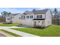 Inviting two-story residence with a two-car garage, adjacent to a sidewalk and grassy front yard at 1950 Van Allen Ct, Dacula, GA 30019