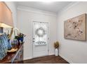 Well-lit foyer featuring elegant decor, a stylish dresser, and neutral-toned artwork at 218 Jordan Dr, Woodstock, GA 30188