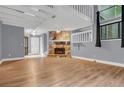 Spacious living room featuring a stone fireplace, hardwood floors, and a view of the mezzanine above at 260 Lamplighter Se Ln, Marietta, GA 30067