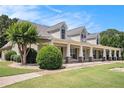 Side view of a lovely one-story home with a long, covered front porch and manicured landscaping at 130 Honey Ln, Fayetteville, GA 30214