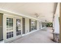 Covered front porch with stone columns, multiple entry doors, and ceiling fans at 130 Honey Ln, Fayetteville, GA 30214