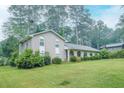 A well-kept brick home with a spacious lawn, complemented by mature trees in a serene, natural setting at 4244 Dorsey Sw Ct, Lilburn, GA 30047