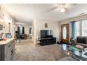 Inviting living room featuring plush sofas, a glass coffee table, and an open view to the dining area at 5006 Dantel Way, Stone Mountain, GA 30083