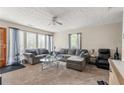 Spacious living room featuring plush sofas, a glass coffee table, and natural light streaming through the windows at 5006 Dantel Way, Stone Mountain, GA 30083