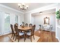 Elegant dining room with hardwood floors, decorative lighting, and ample natural light at 59 Creekside Blf, Hiram, GA 30141