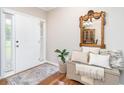 Inviting foyer featuring hardwood floors, a decorative mirror, and a bright white front door at 59 Creekside Blf, Hiram, GA 30141