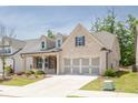 Attractive home boasting brick and siding accents, a covered porch, and a spacious driveway at 1409 Bluffs Ridge Way, Canton, GA 30114