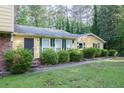 Well-maintained front yard with trimmed bushes and a walkway leading to the front door at 2037 Cliffton Ter, Snellville, GA 30039