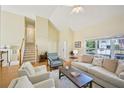 Open-concept living area boasts vaulted ceilings, a staircase, and plenty of natural light at 3705 Tate Pl, Austell, GA 30106
