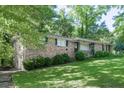 Well-maintained brick home with a green lawn and mature landscaping adding to its curb appeal at 4236 Beaver Ruin Nw Ct, Lilburn, GA 30047