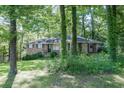 Secluded brick home surrounded by lush greenery and mature trees, offering a private setting at 4236 Beaver Ruin Nw Ct, Lilburn, GA 30047