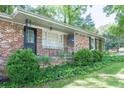 Cozy brick home with manicured bushes and vines adding to its inviting charm at 4236 Beaver Ruin Nw Ct, Lilburn, GA 30047