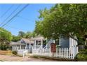 A quaint home surrounded by lush greenery and a white picket fence at 481 Glenwood Se Ave, Atlanta, GA 30312