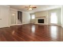 Living room featuring hardwood floors, a fireplace with brick surround and French doors at 5243 Valleyview Dr, Acworth, GA 30102