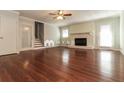 Spacious living room features hardwood floors, a brick fireplace, and abundant natural light from the large glass doors at 5243 Valleyview Dr, Acworth, GA 30102